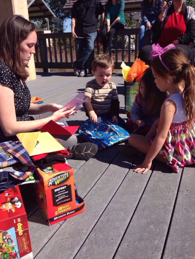Aiden's (our nephew) 2 year old birthday party. He is opening the gift we gave him. He looks pumped:)