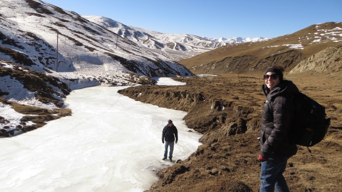 Frozen river cutting through the mountains.
